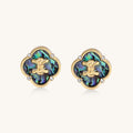 Gold-plated quatrefoil stud earrings featuring iridescent abalone shell centers with decorative motifs and crystal accents