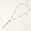 Long gold-plated lariat necklace featuring baroque pearls with metal caps arranged in elegant Y-shape design
