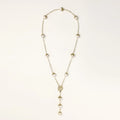 Long gold-plated lariat necklace featuring baroque pearls with metal caps arranged in elegant Y-shape design