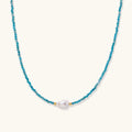 Delicate necklace featuring small turquoise apatite beads with a central freshwater pearl on sterling silver chain