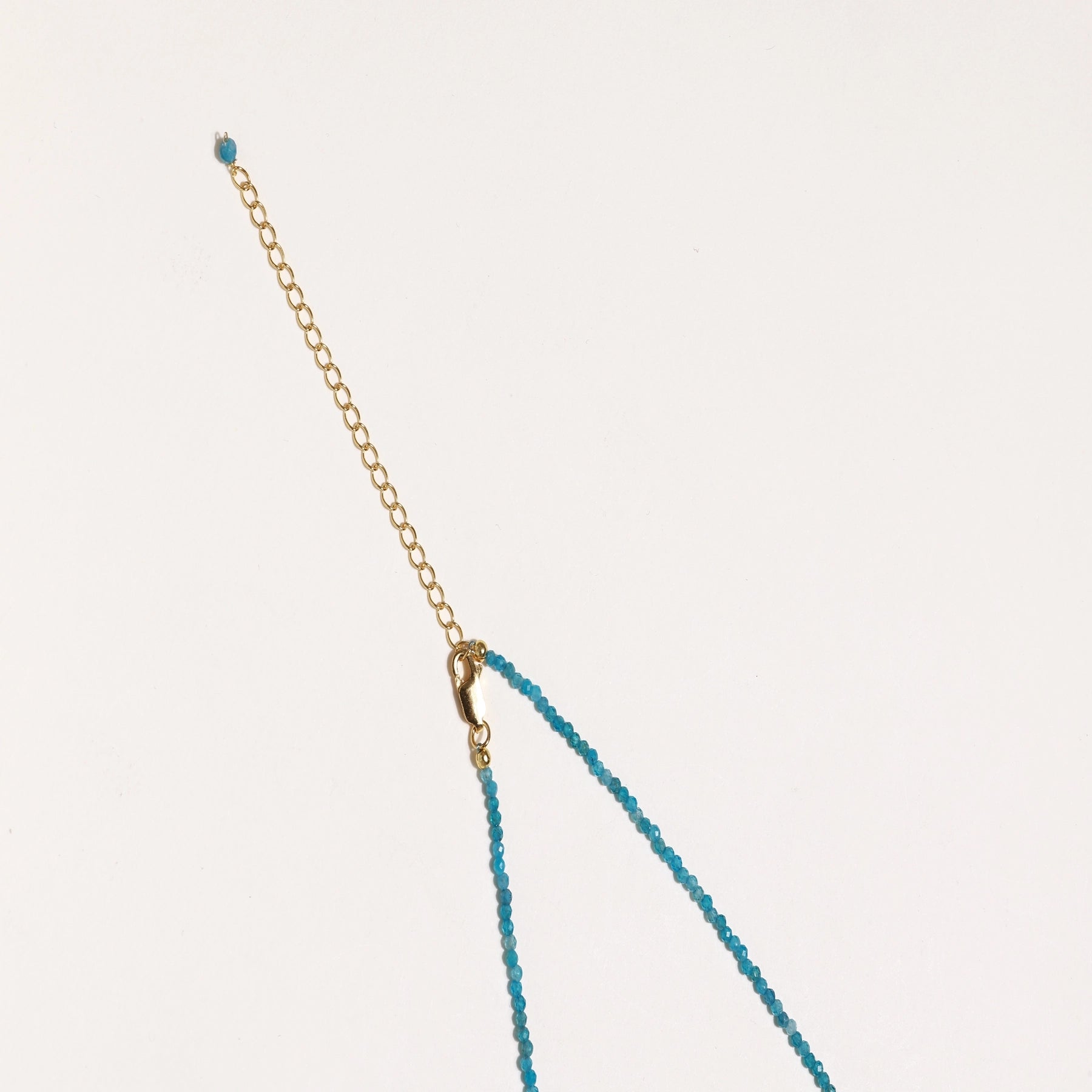 Delicate necklace featuring small turquoise apatite beads with a central freshwater pearl on sterling silver chain