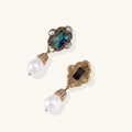 Gold-plated brass drop earrings featuring iridescent abalone shell centers, crystal accents, and white pearl drops.