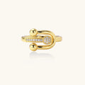 Modern gold-plated adjustable ring with safety pin design and sparkling cubic zirconia accents on white background
