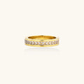 14K gold plated ring with channel-set zirconia stones and Greek key pattern engraved on sides on white background